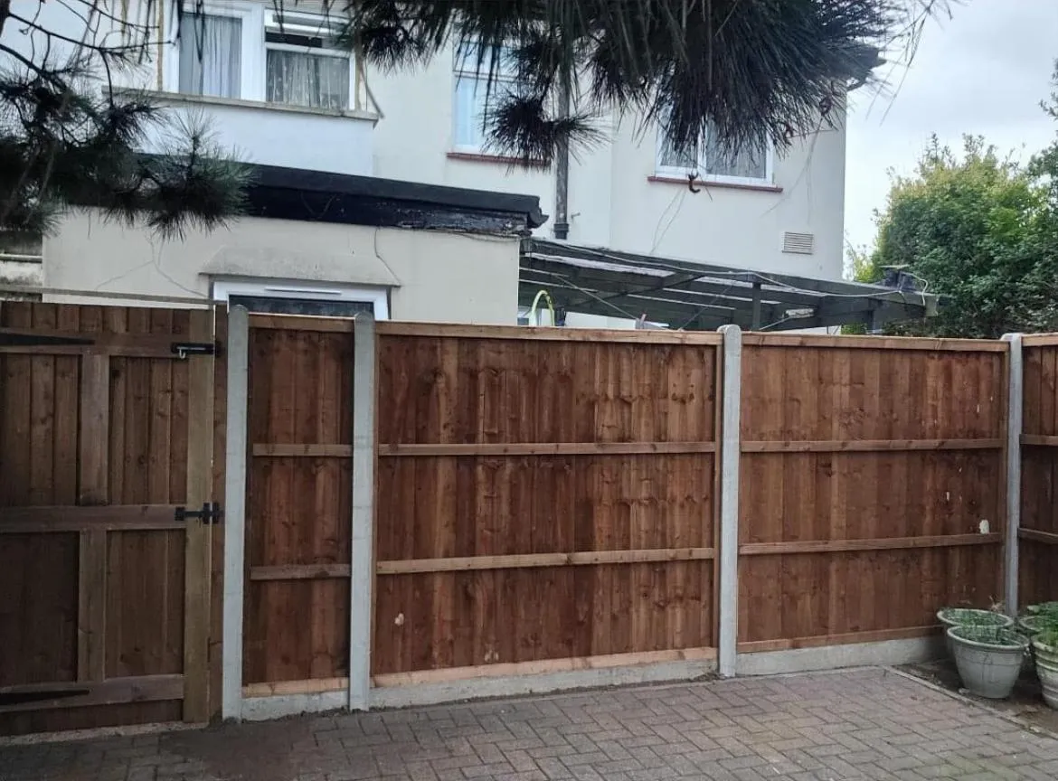 A wooden fence in front of a house.