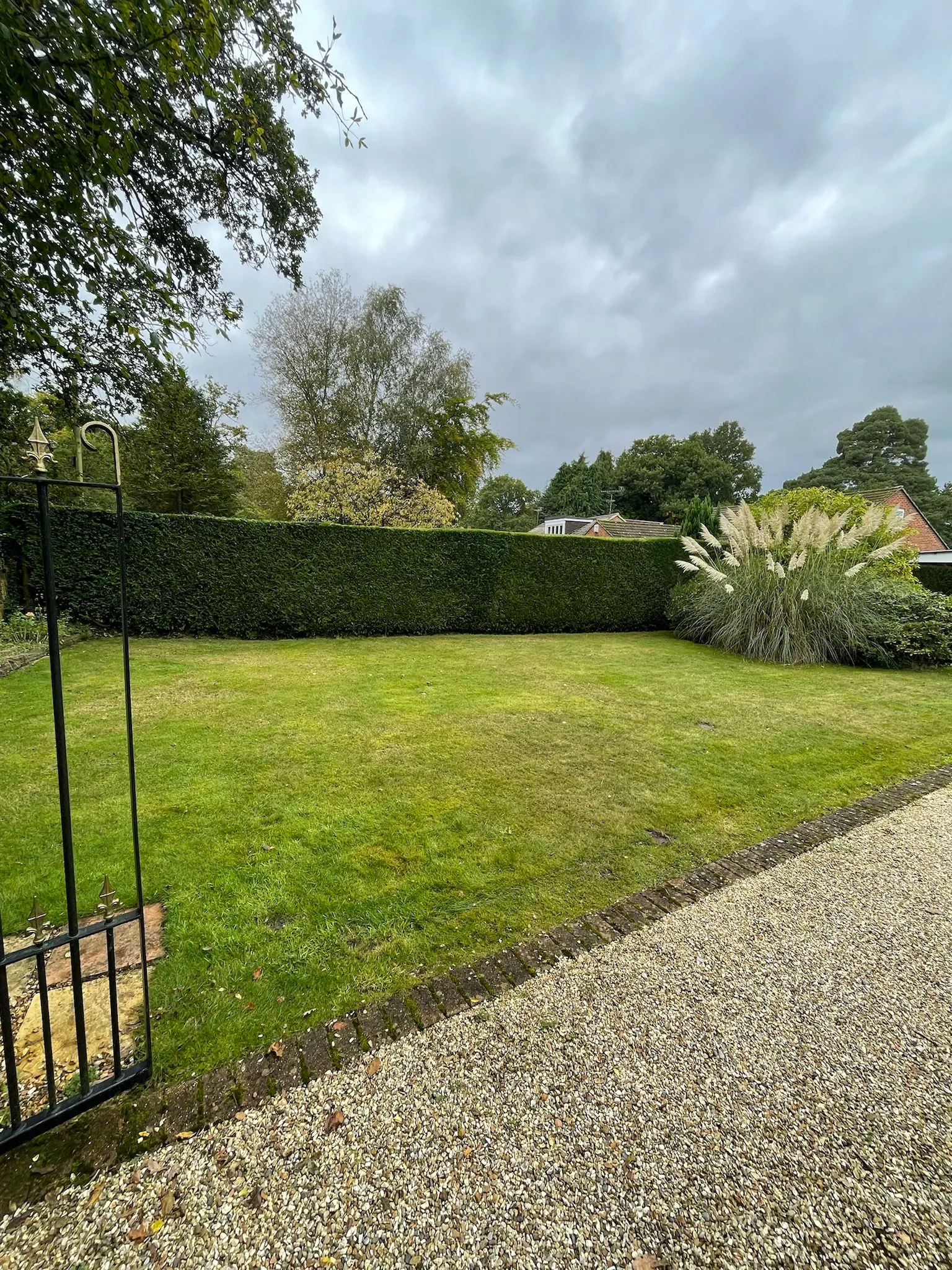 A large yard with a fence and grass.